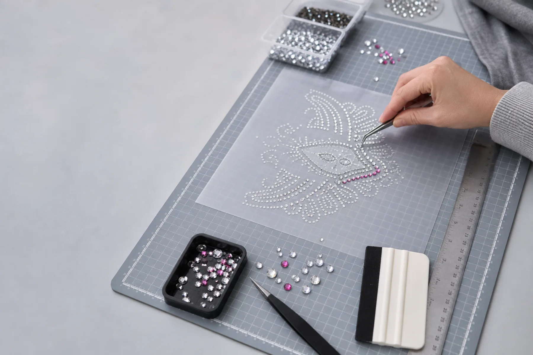 Rhinestone template workbench with stones, ruler, and placement tools